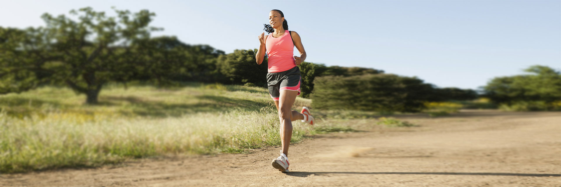 Woman running on a dirt road