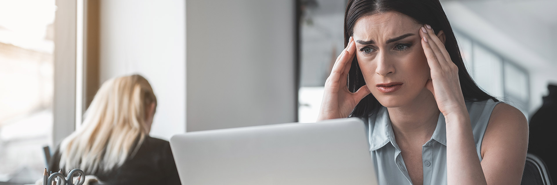 Woman looking stressed at her laptop