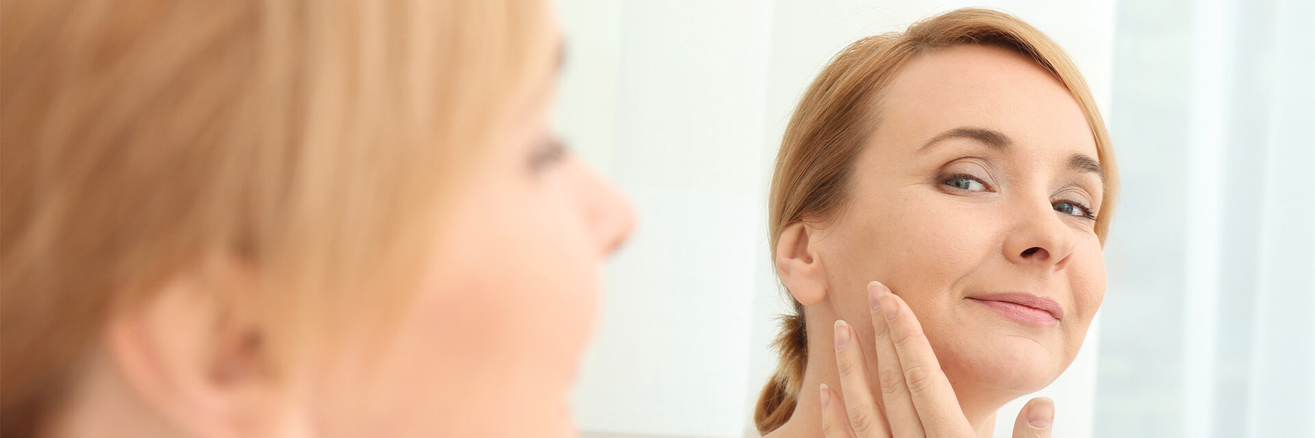 Woman looking at herself in the mirror