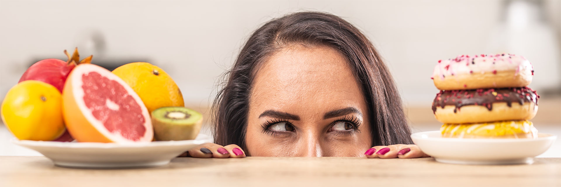 Woman looking at healthy and UNhealthy snacks