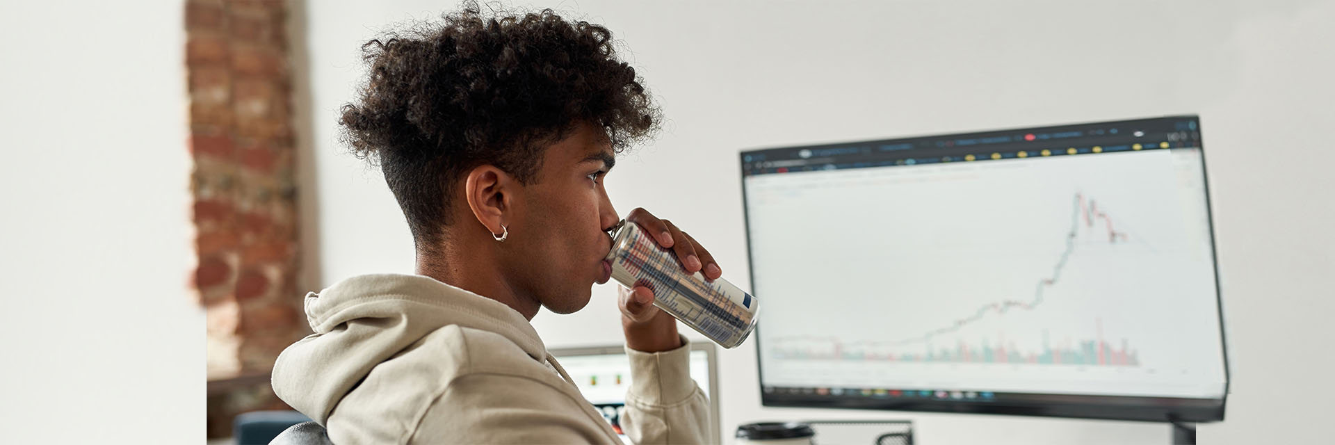 Young man drinking from small can