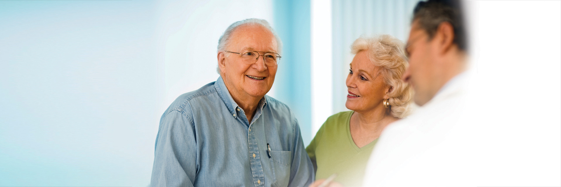 Mature man and wife talking to provider