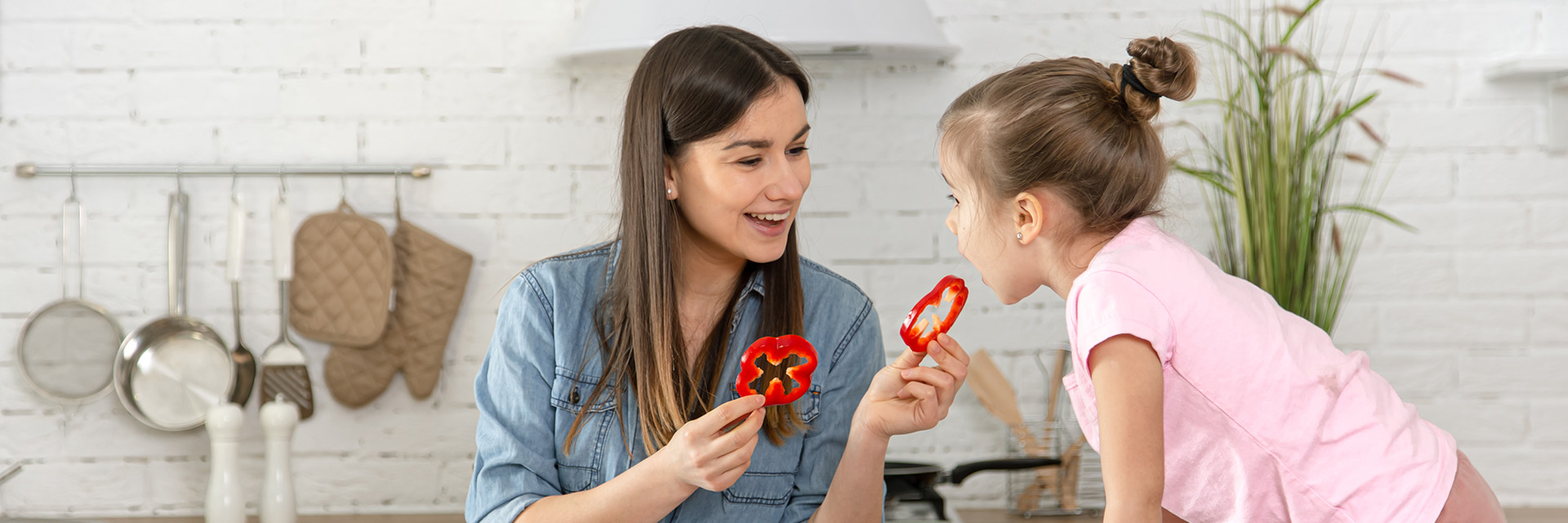 Mom feeding daughter