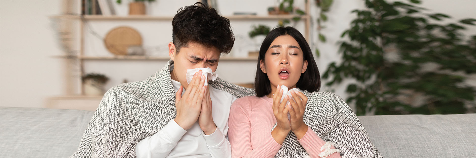 Couple sitting on couch with allergies
