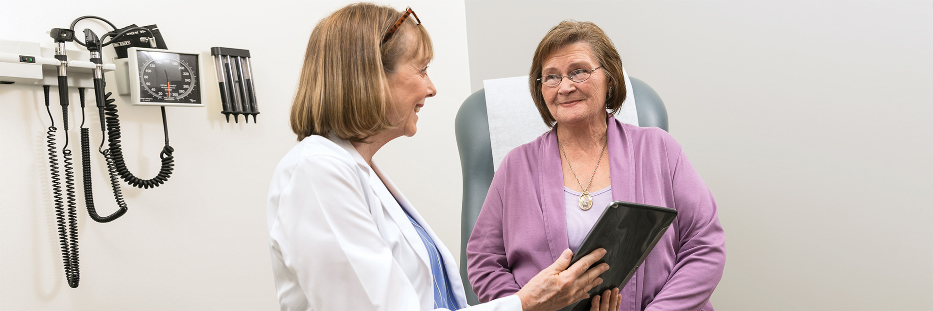 Mature woman and mature doctor in office consultation