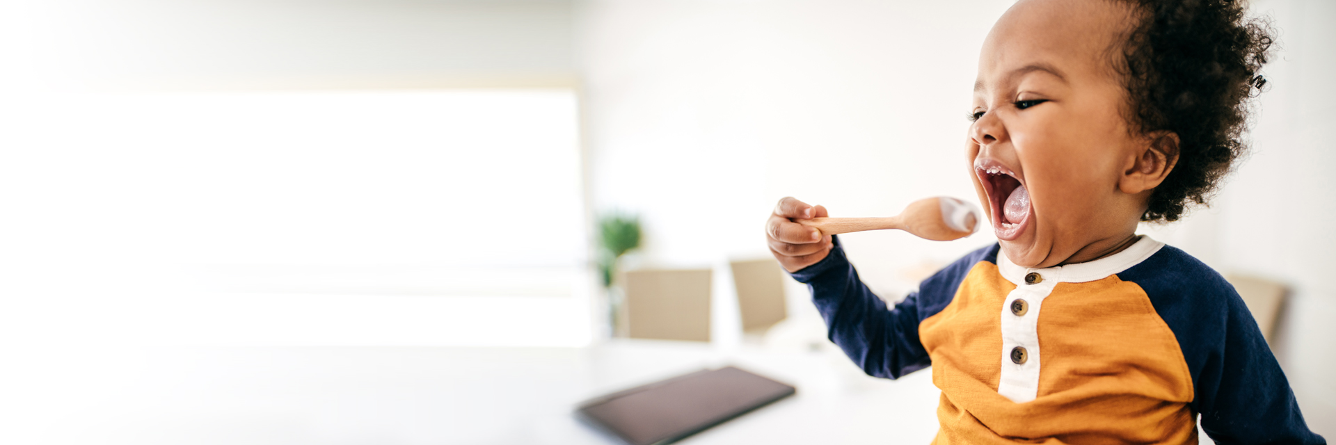 Little boy with wooden spoon