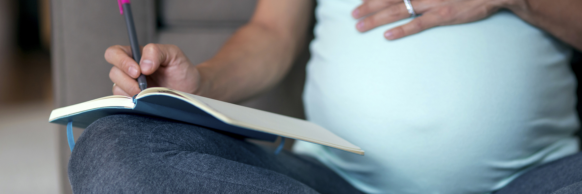 Woman sitting on the floor writing in journal