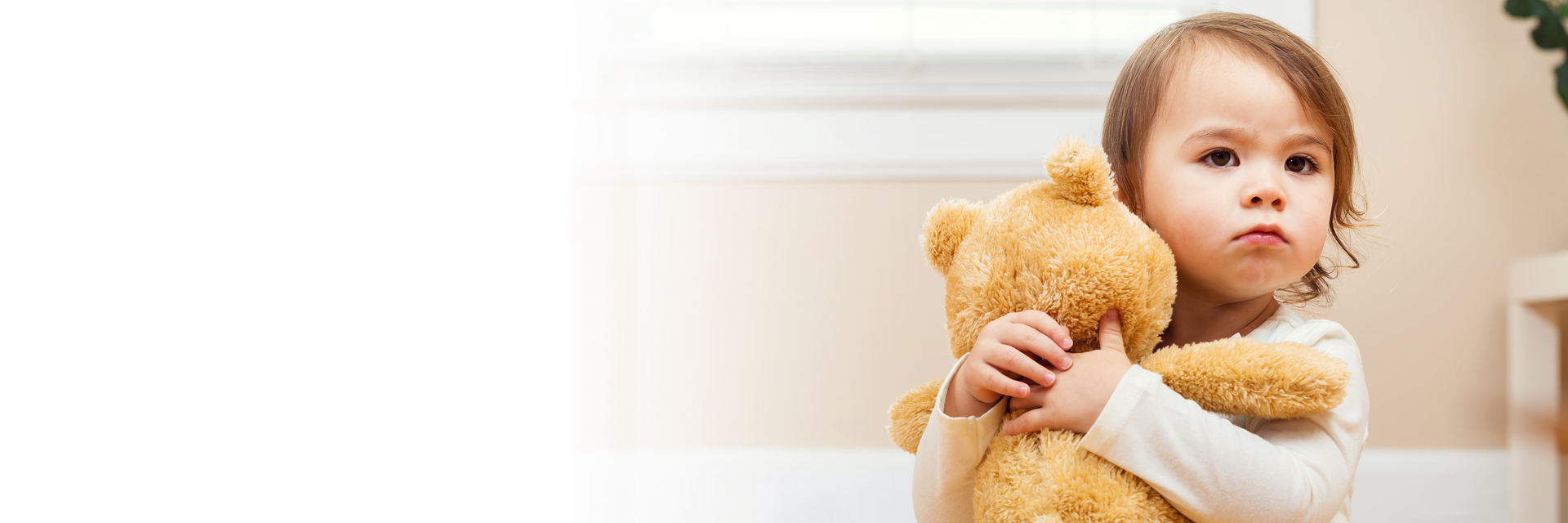 Baby holding teddy bear