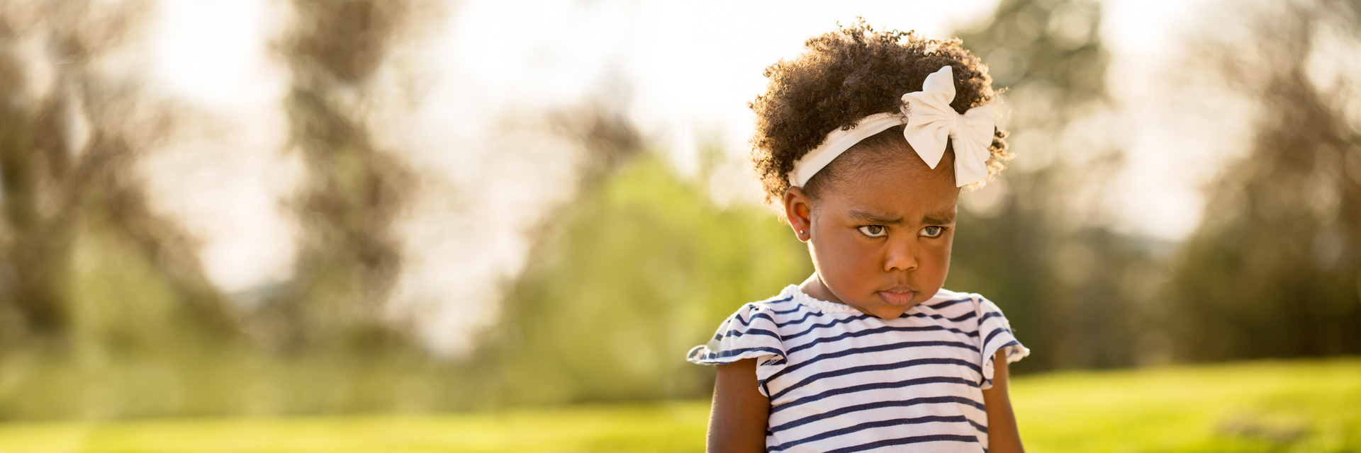 Little girl outdoors upset