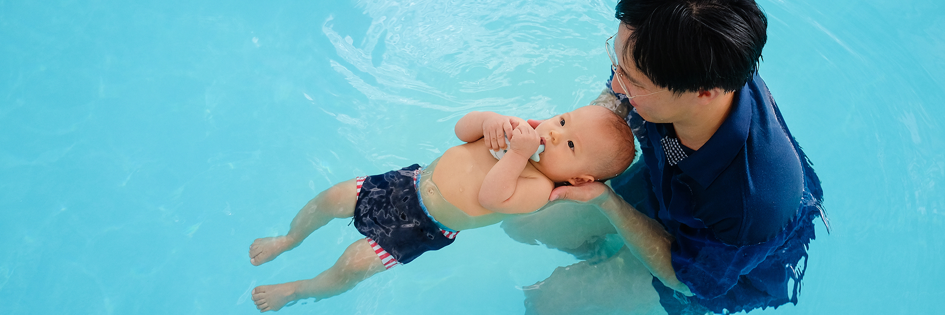 Dad with baby boy in pool