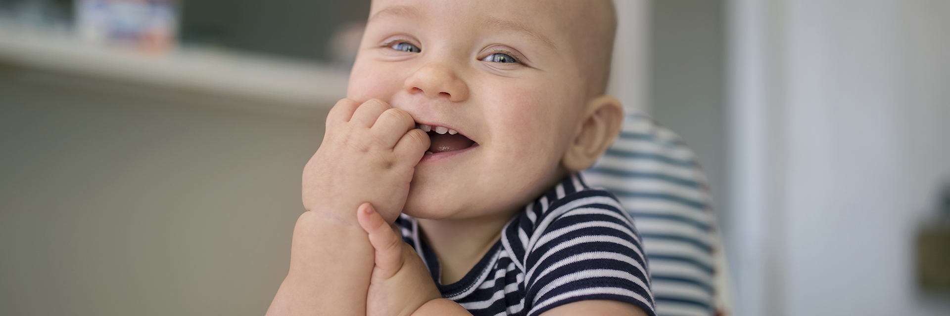Baby boy smiling in stripe shirt