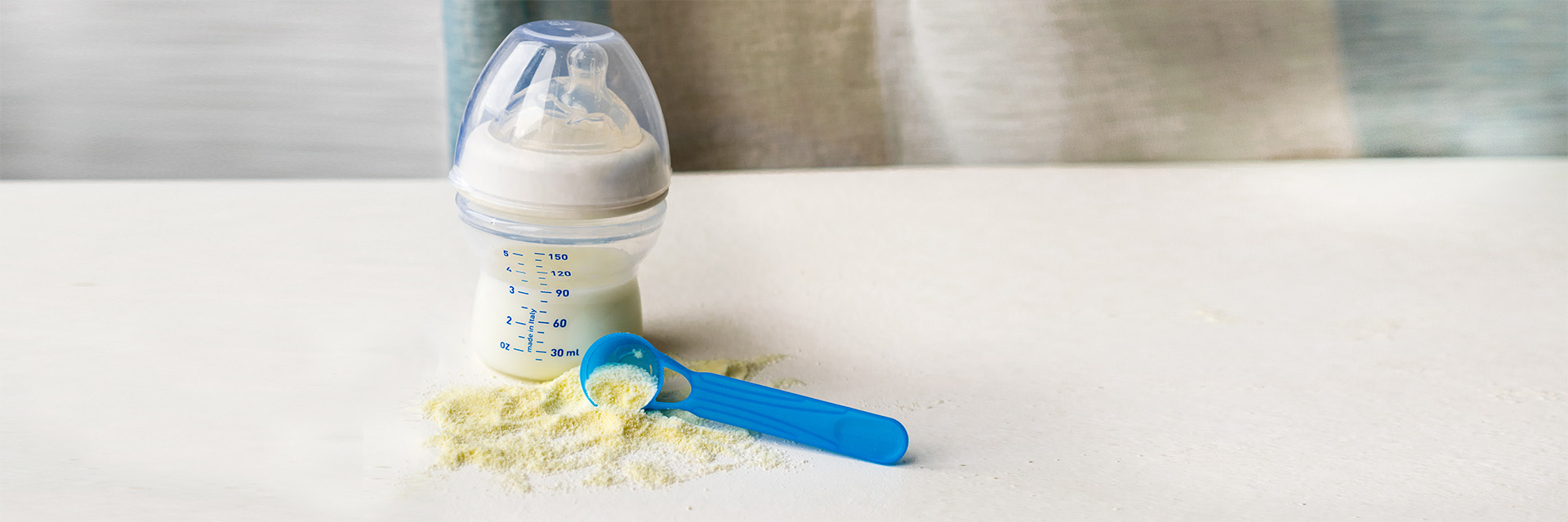 Baby bottle and formula on counter