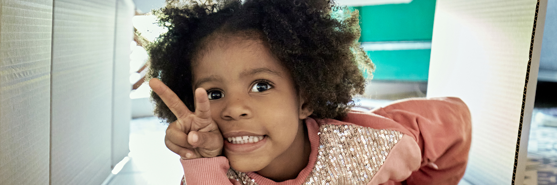 Little girl making a peace sign with her fingers