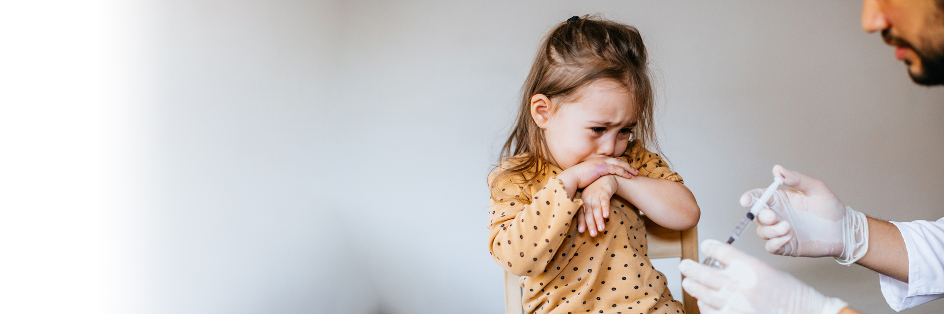 Little girl scrying while getting a shot