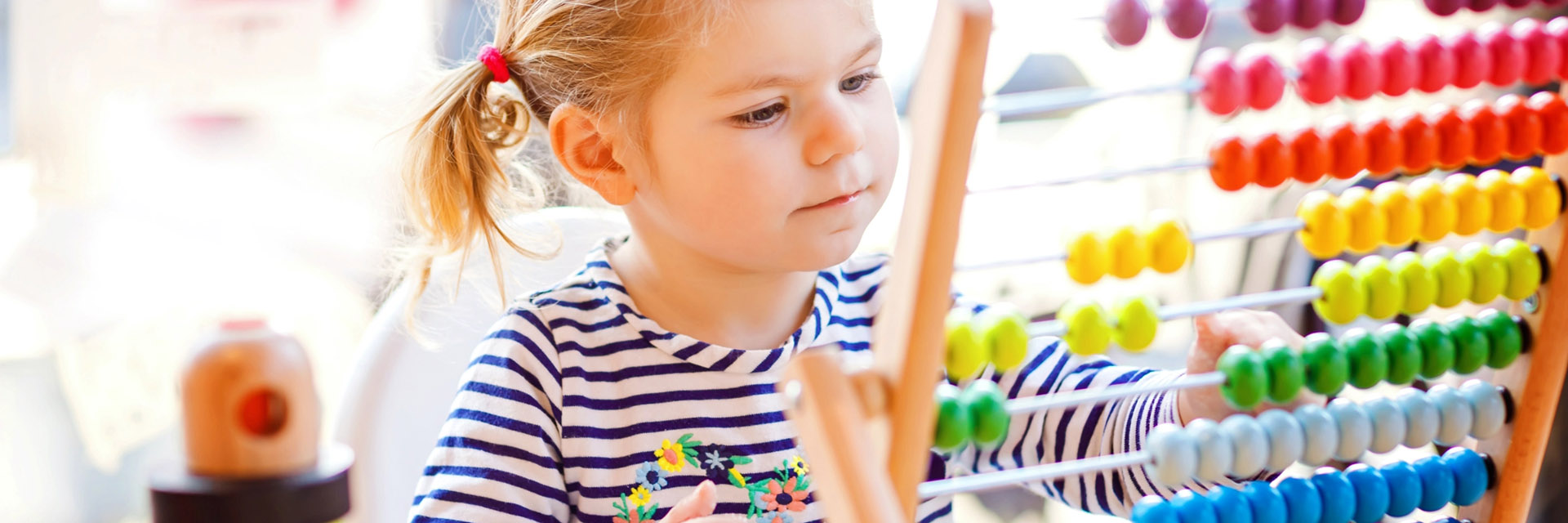 Little girl playing with abacus