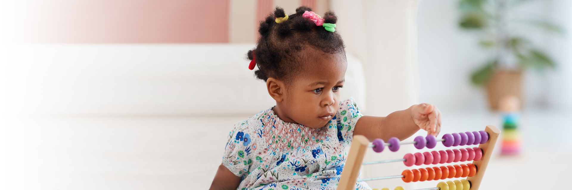 Infant girl playing with abacus
