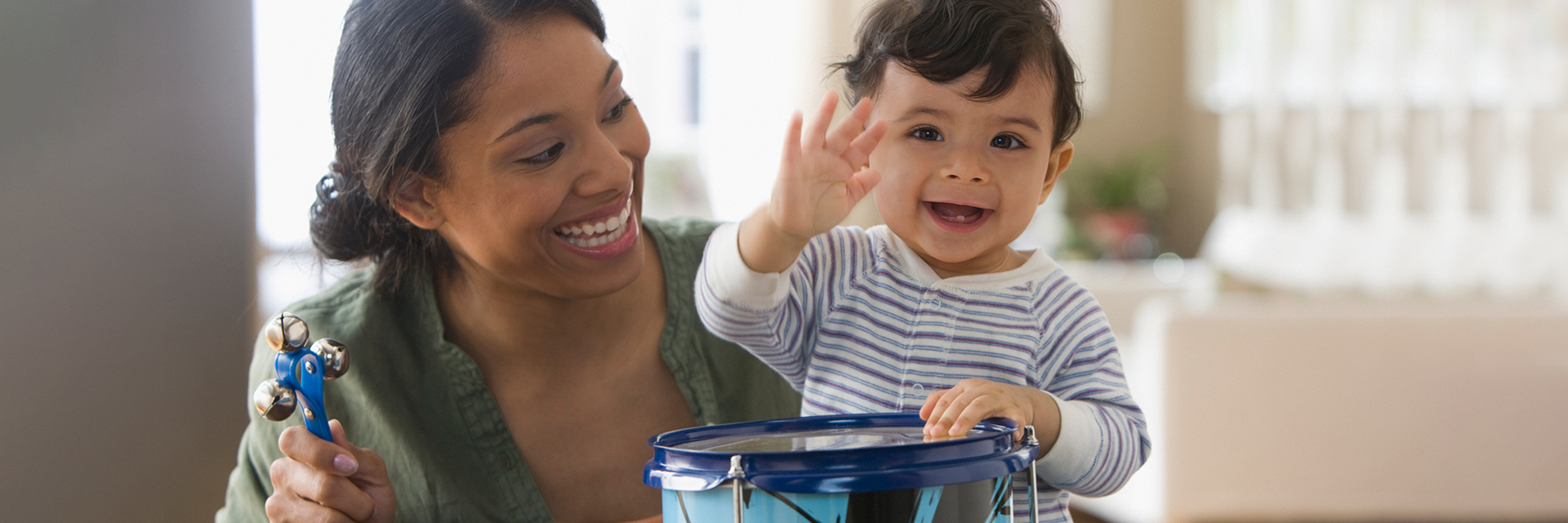 Baby and mom playing with drum