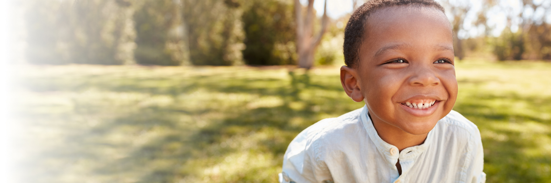 Little boy outdoors smiling