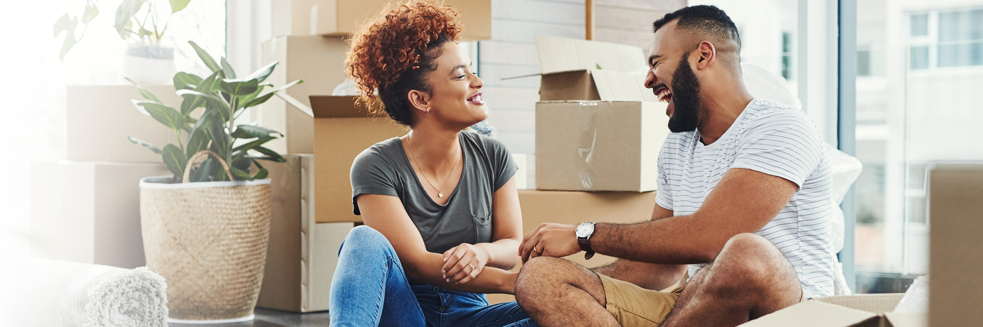 Man and woman sitting down laughing