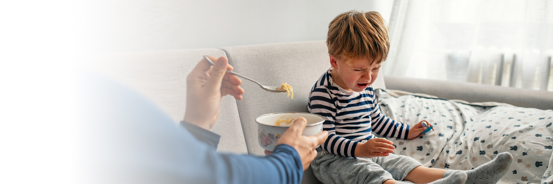 Parent feeding crying child