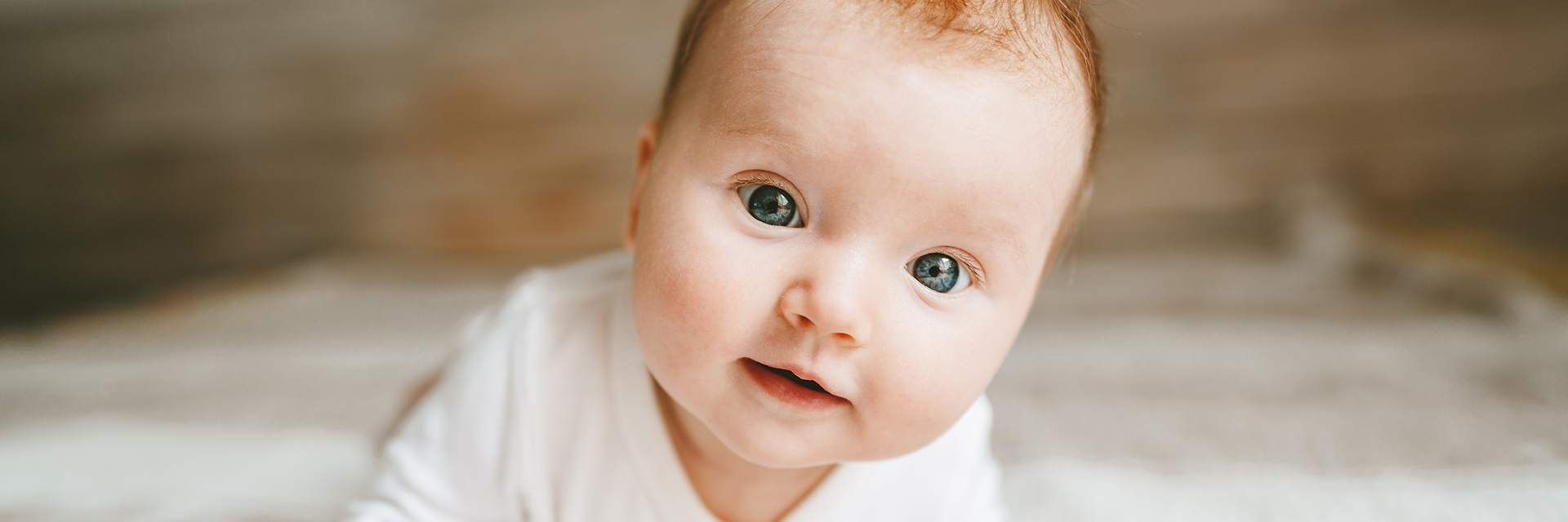 Baby crawling in white top