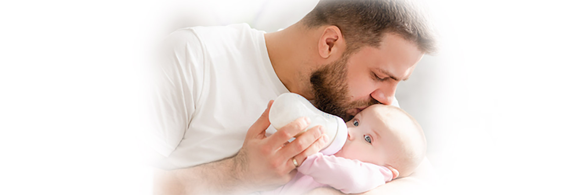 Dad feeding baby bottle