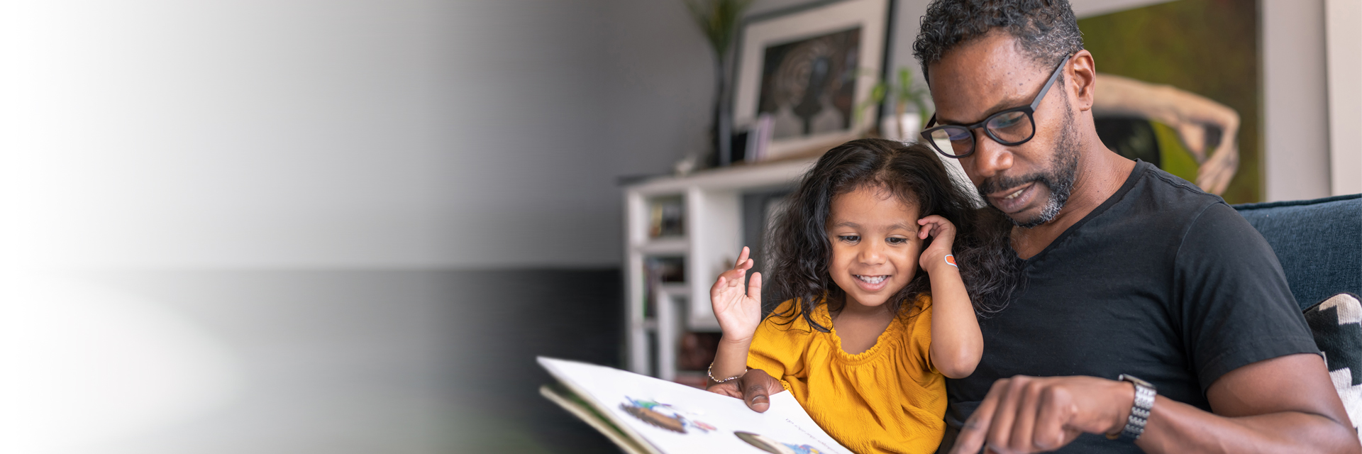 Dad reading to little girl