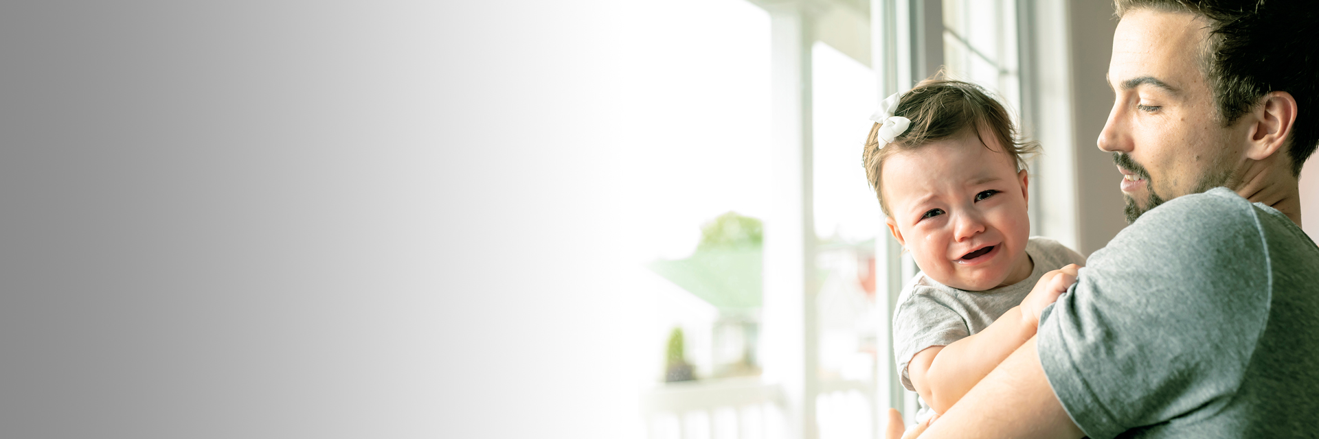 Dad holding crying baby