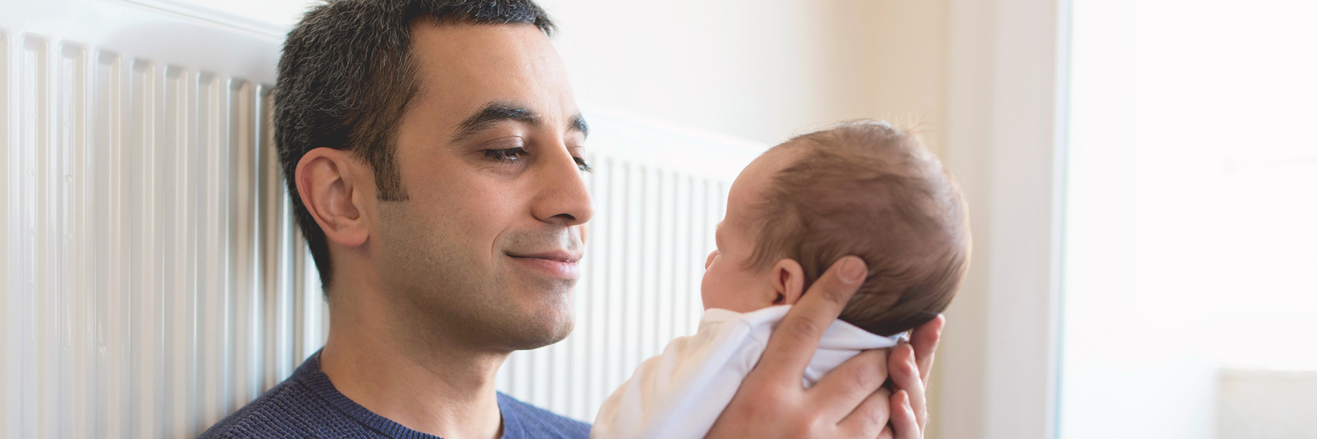 Dad holding infant baby