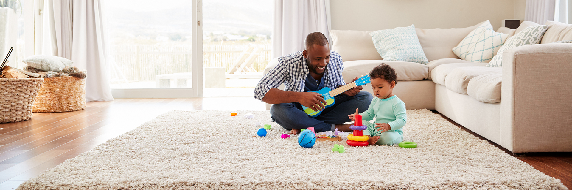 Dad and baby playing in living room