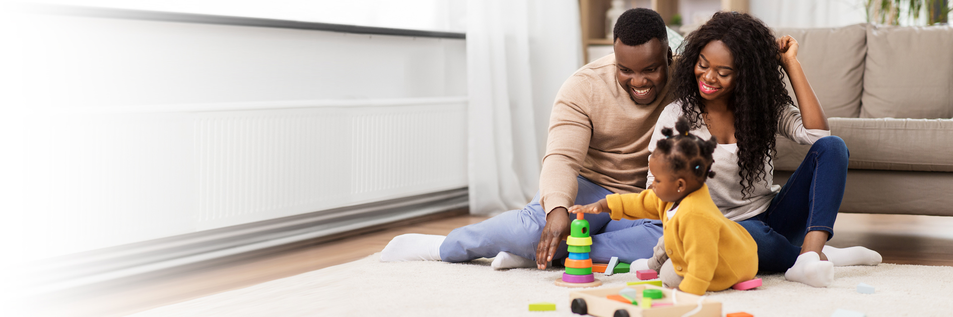 Mom and dad playing with little girl
