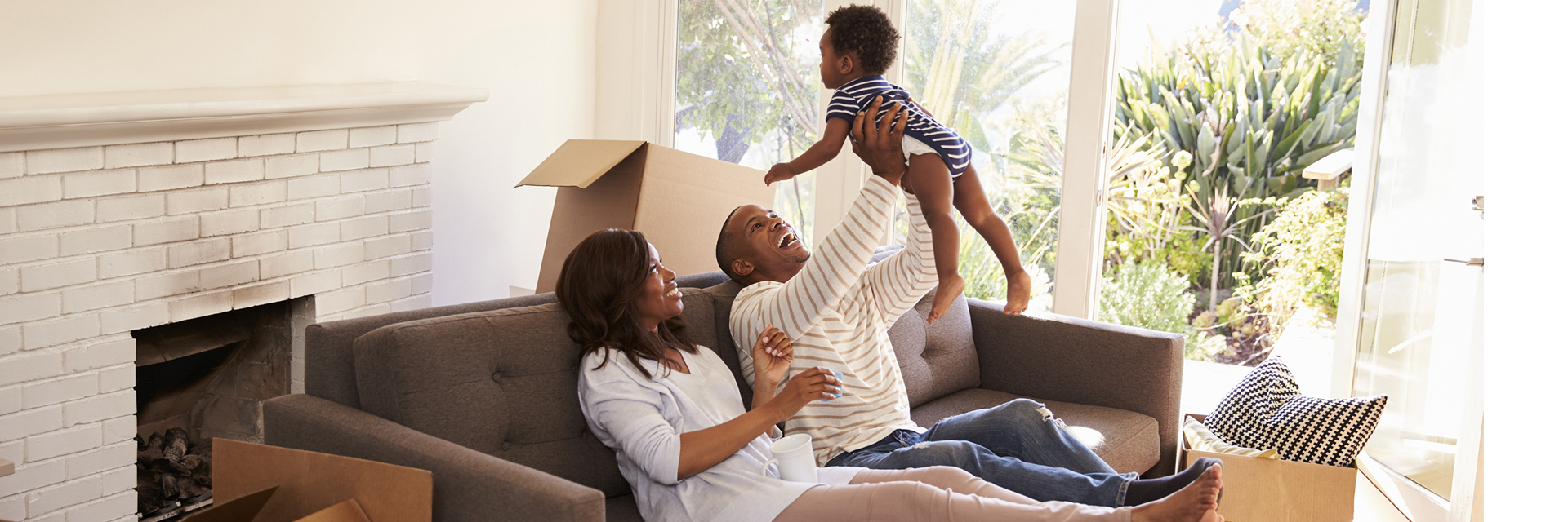 Parents playing with infant on couch