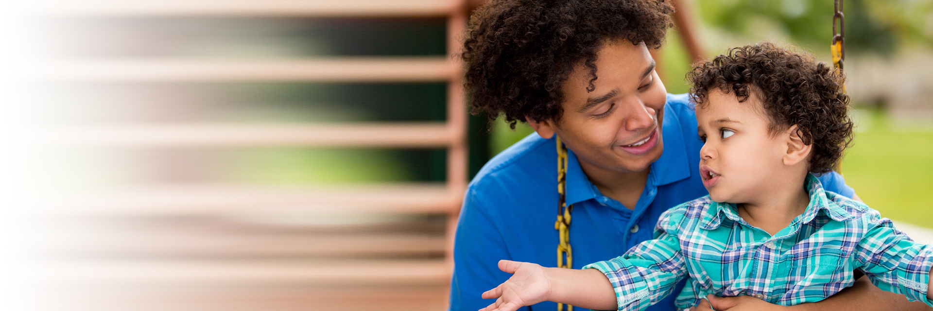 Dad and little boy in swing