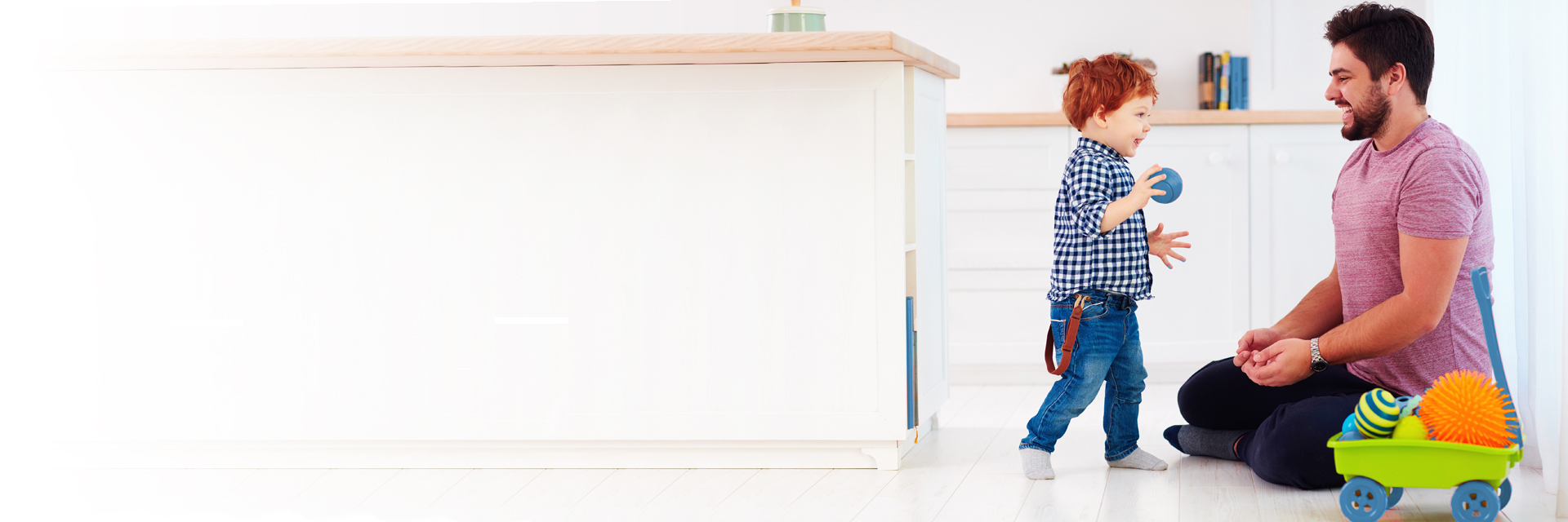 Dad and son playing in kitchen