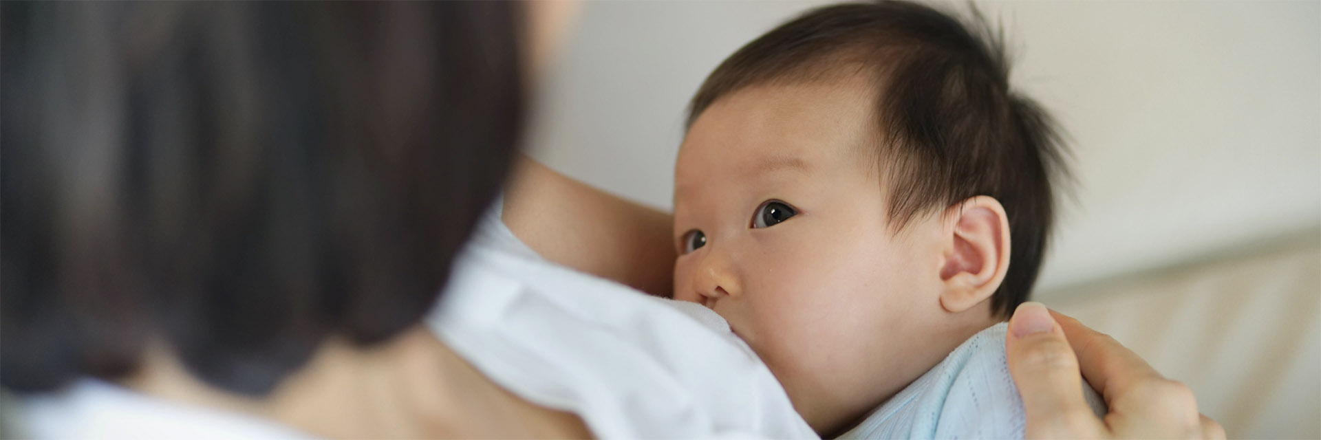 Mom breastfeeding baby boy
