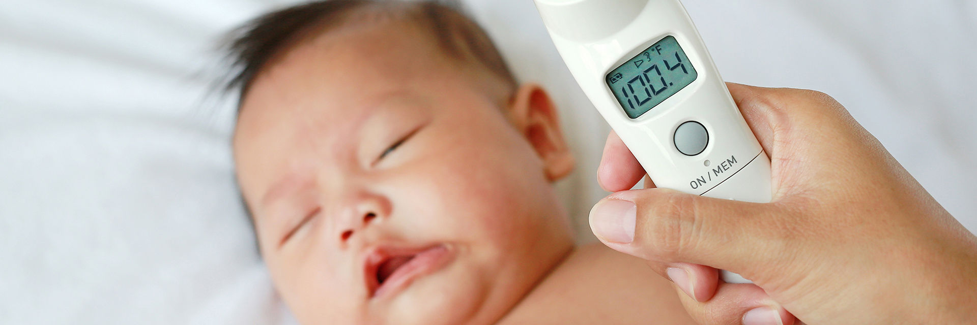 Baby getting temperature checked