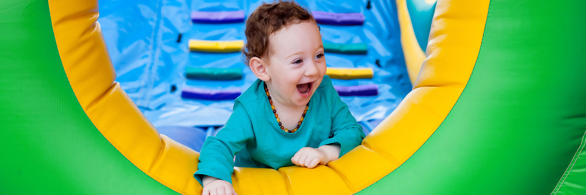 Smiling boy playing in bounce house