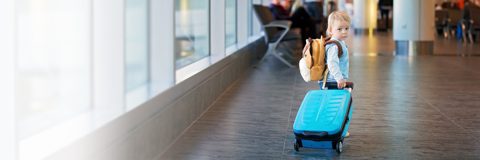 Toddler with suitcase at airport