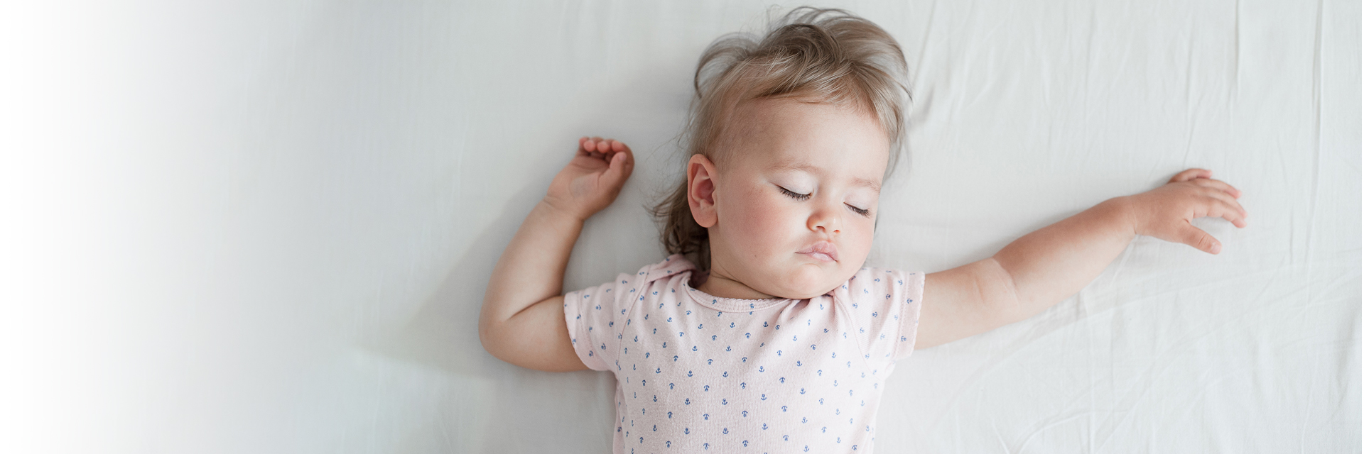 Baby girl sleeping in bed