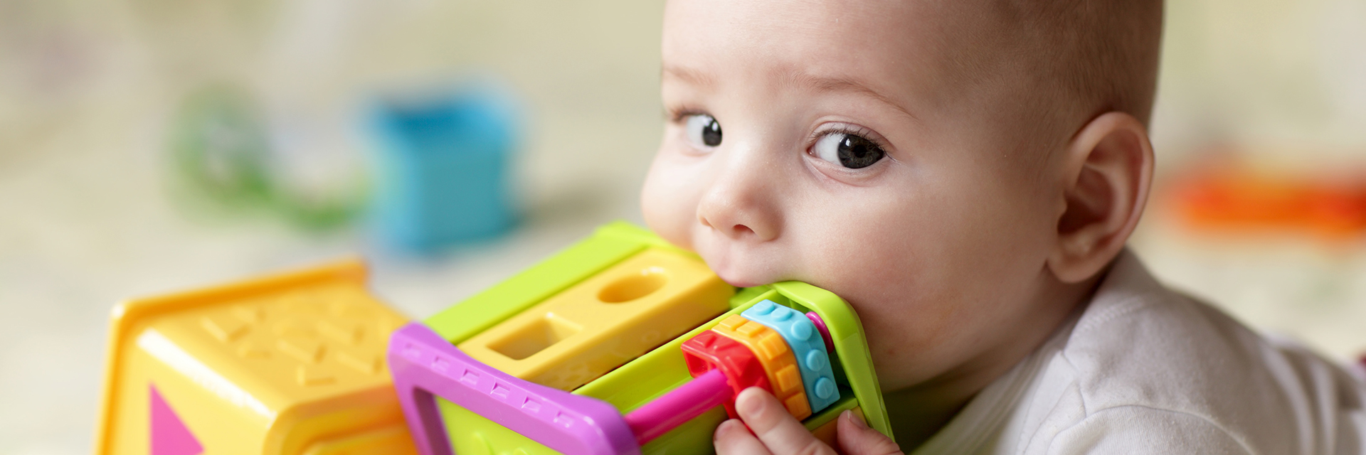 Baby playing with toy in mouth