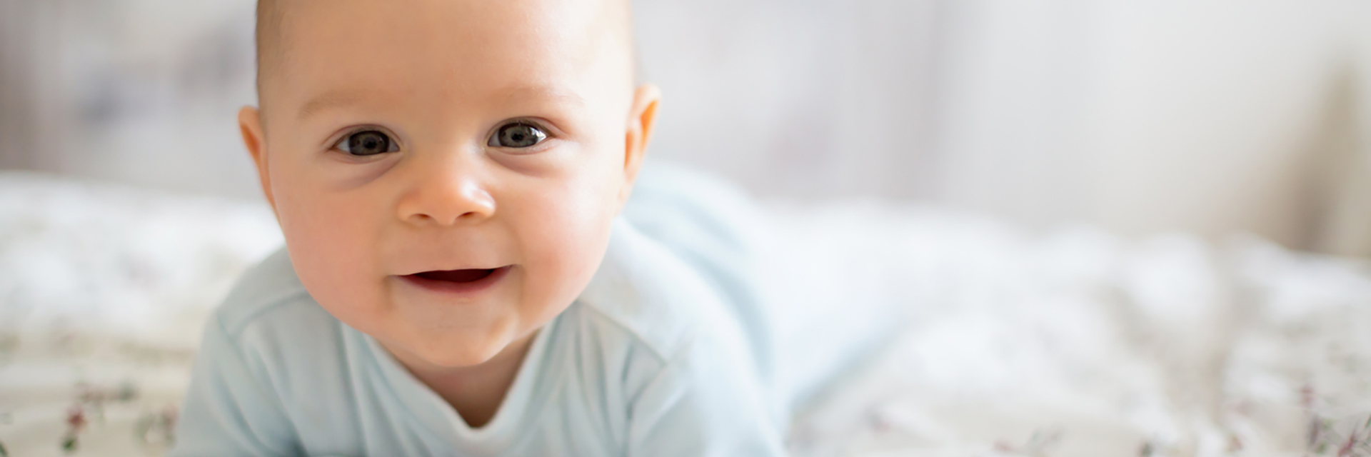 Infant smiling on blanket