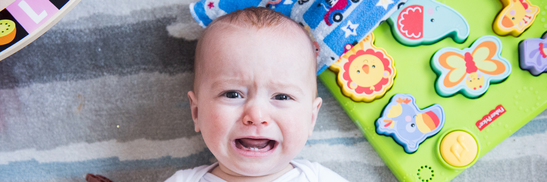 Little boy laying on the floor crying