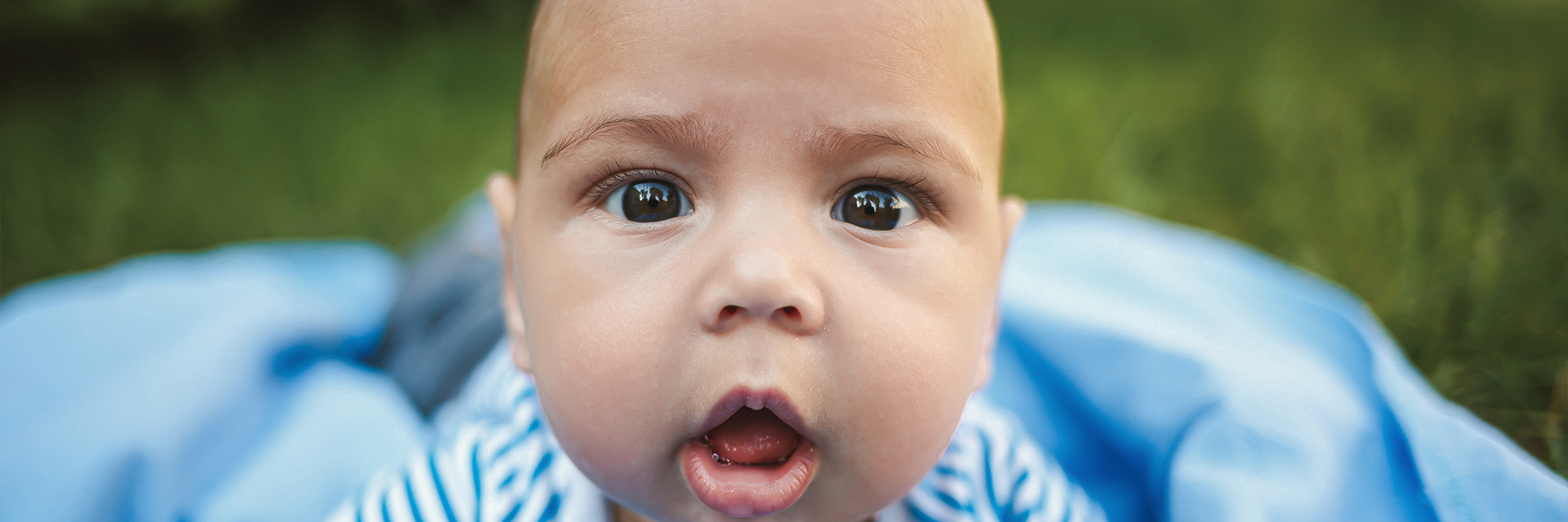 Little boy outdoor with curious face