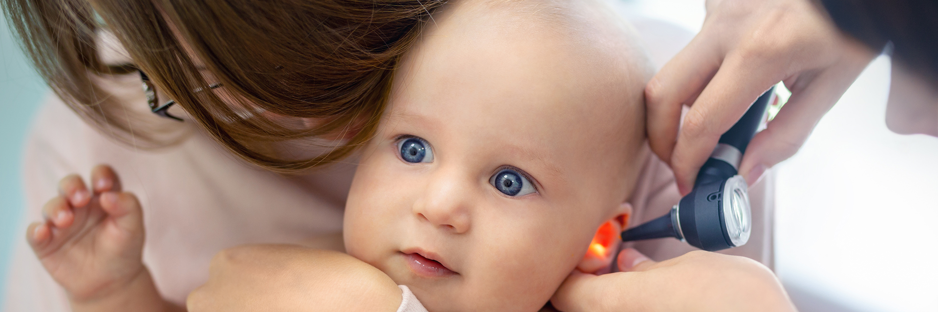 Mom holding aby at checkup