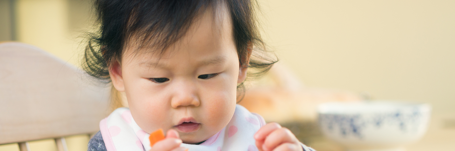 Infant eating carrot