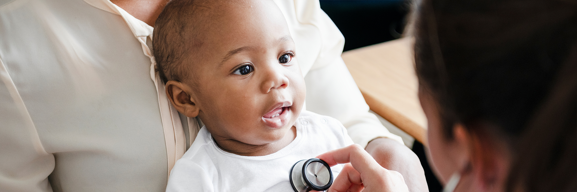 Baby at exam with stethoscope