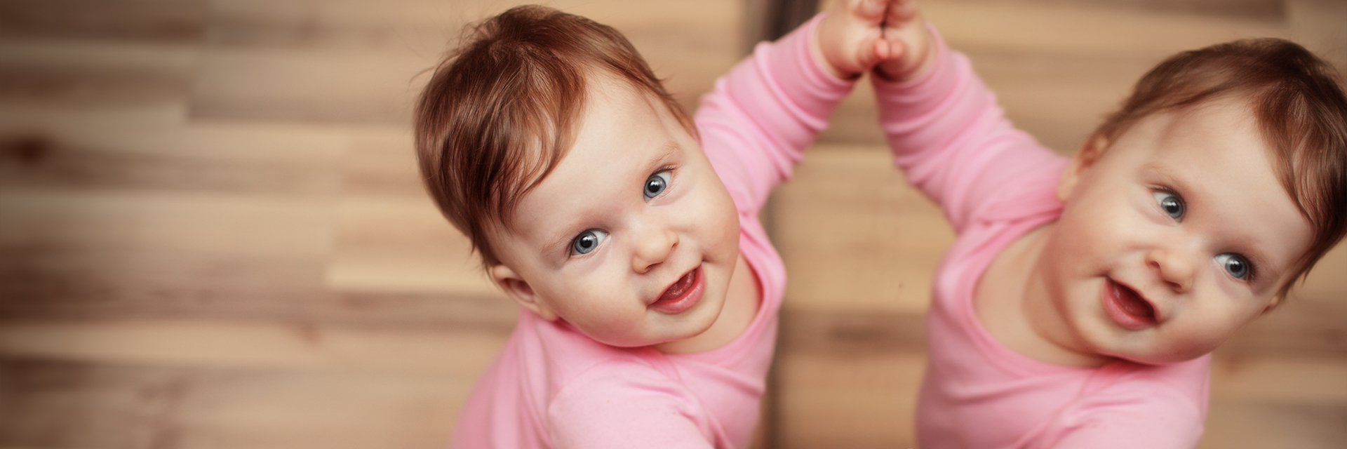 Little girl playing in front of mirror