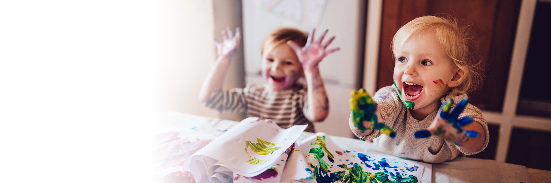Kids finger painting at table