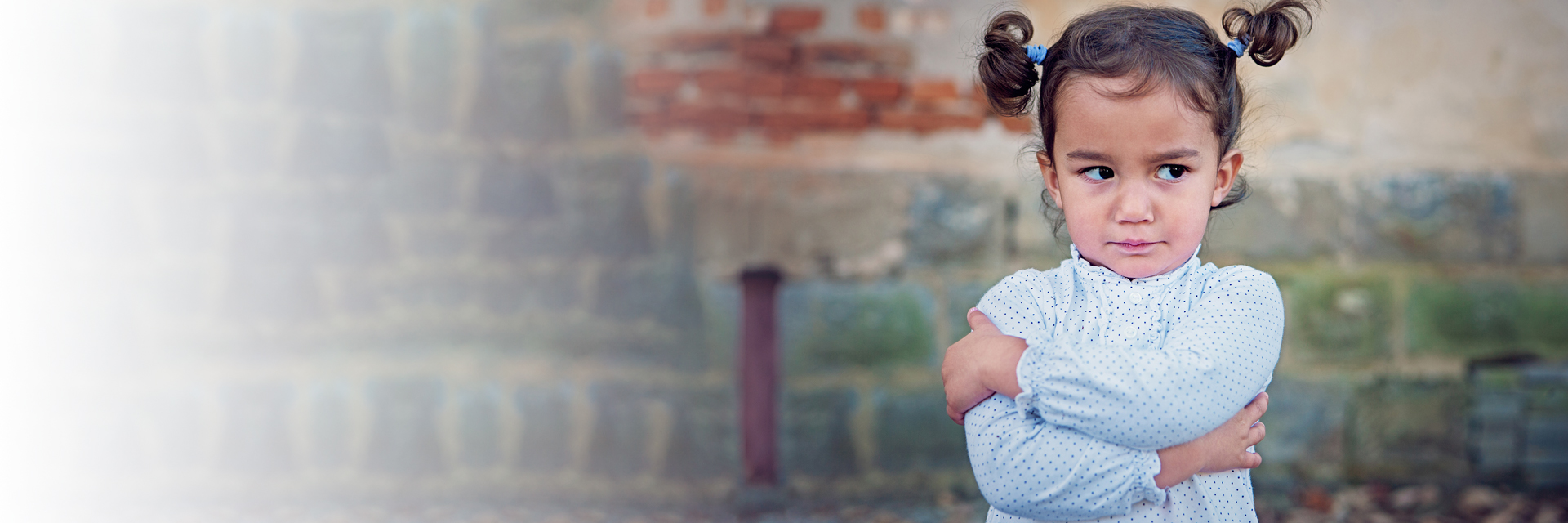 Little girl with arms folded