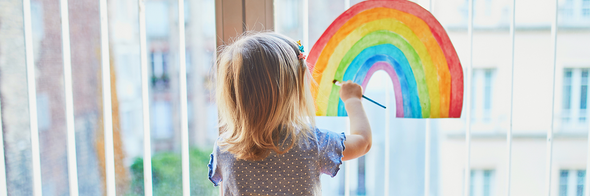 Little girl painting rainbow